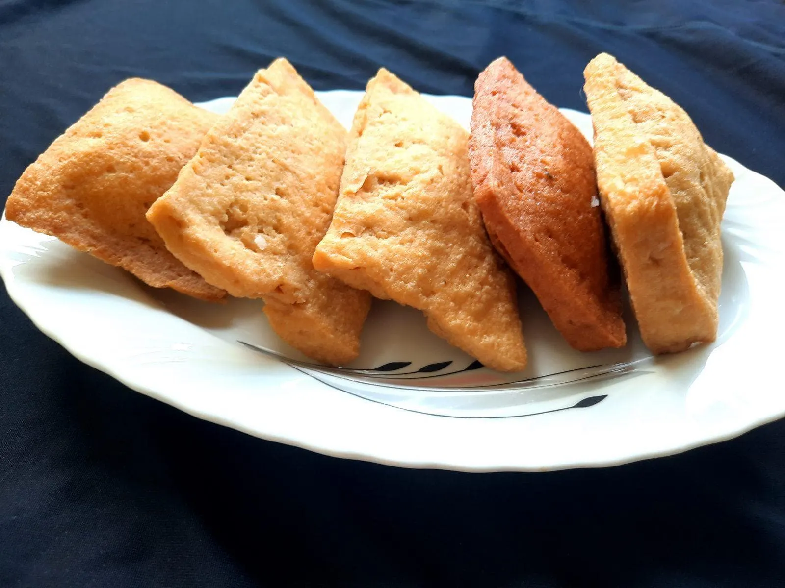 Inari sushi tofu pockets filled with seasoned rice, arranged on a plate