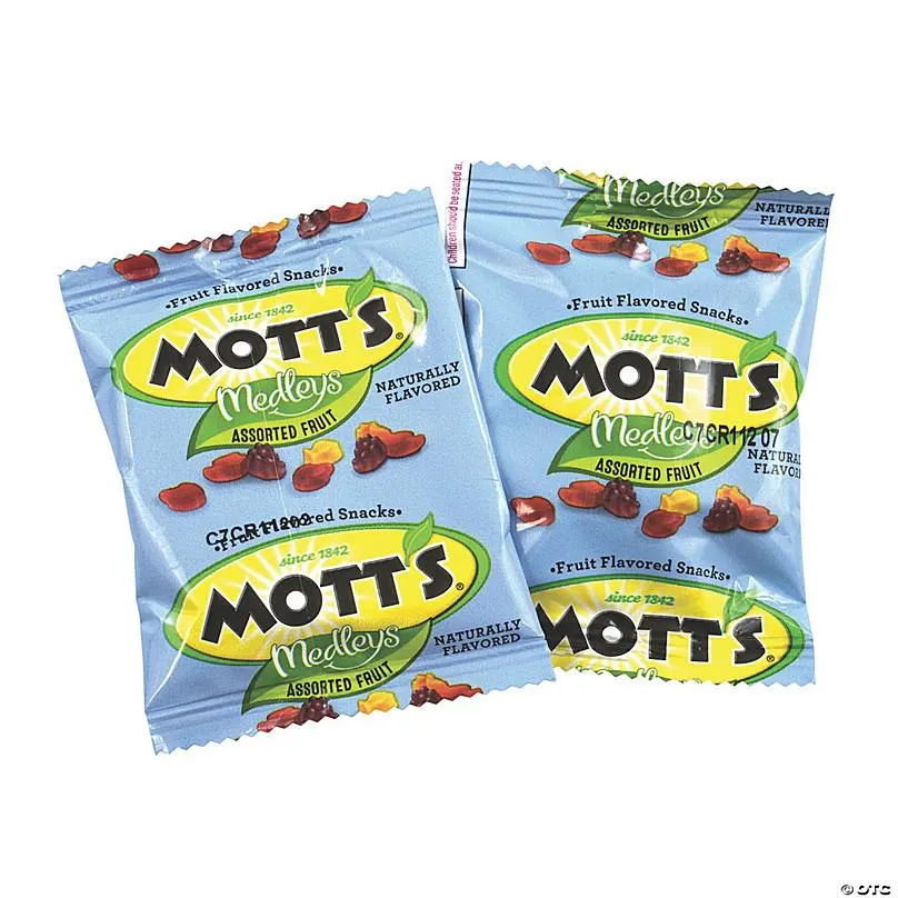 A packet of Mott's fruit snack gummies with pieces scattered beside it