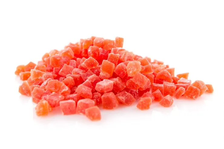 A close-up shot of red, naturally dried peach gums. The vibrant red colour and textured surface emphasize their dried and preserved state.