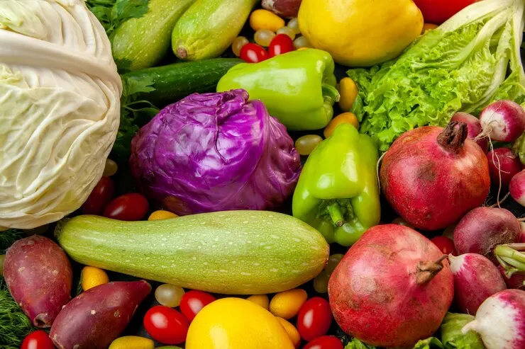 Bottom view vegetables fruits zucchini bell peppers cherry tomatoes cumcuat cucumber lettuce red white cabbage pomegranates radish