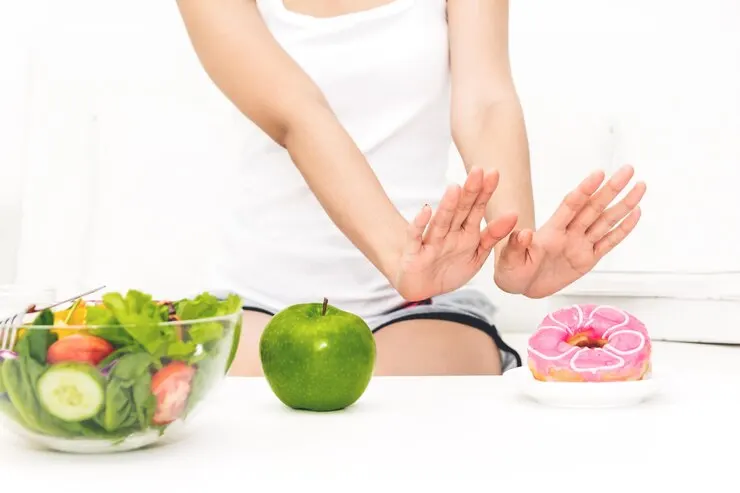 Midsection woman refusing donut table