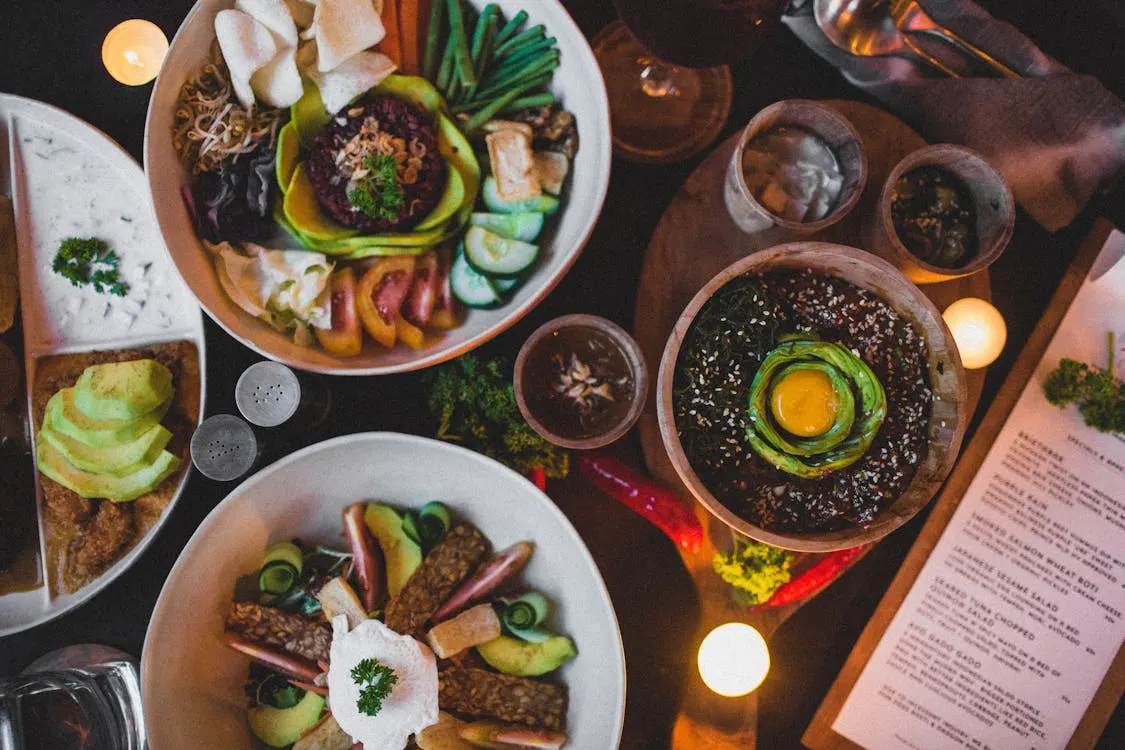 A beautifully arranged table featuring an array of vegan dishes and drinks, showcasing Michelin Star elegance.