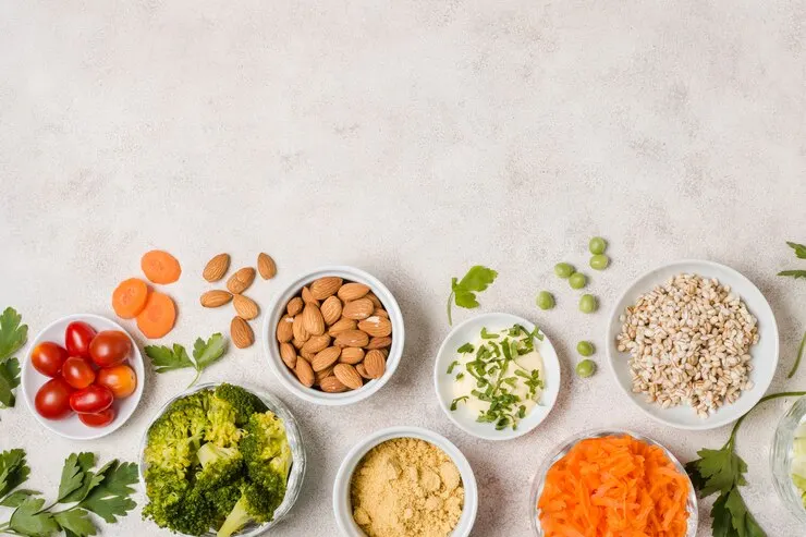 A colourful display of healthy foods in bowls, emphasising a fibre-rich vegan diet that promotes regular digestive health.
