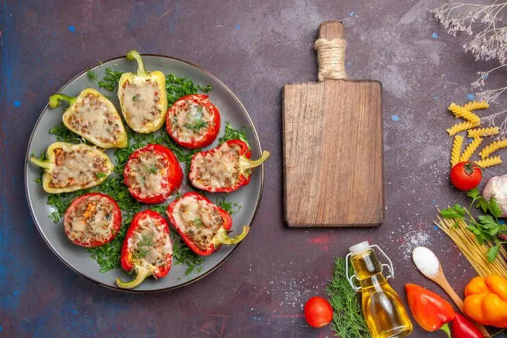 Top view baked bell peppers delicious meal with meat inside greens dark desk dinner food dish meal bake