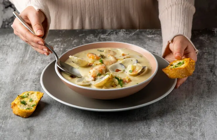 Close up hand holding spoon bread