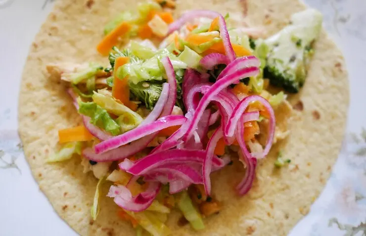  A colourful taco topped with vegetables and onions, highlighting the essence of the best vegan cauliflower tacos.