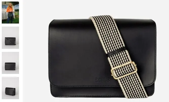 A black leather messenger bag featuring a stylish striped strap, showcasing the chic vegan design of the Uppeal™ material.