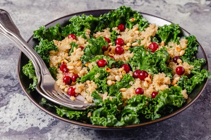  A vibrant Cornucopia Kale Salad with cranberry quinoa topped with pomegranate seeds, perfect for a romantic Valentine's Day meal for two.