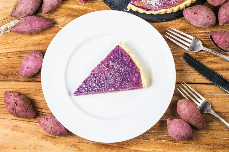 A slice of purple filling pie on a plate, perfect for celebrating Valentine's Day with The Great Purple Sweet Potato Pie.