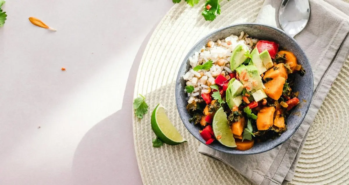 A plant-based grain bowl with lime, coriander and roasted vegetables