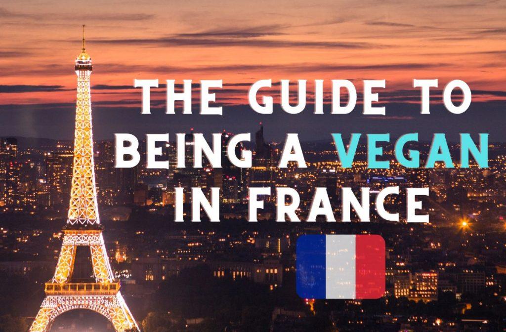 An evening view of the Eiffel Tower illuminated against a cityscape at sunset. Overlaid text reads: "The Vegan Guide to France" with a small French flag beside it.