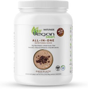 A white container of Naturade Vegan Smart All-In-One Nutritional Shake is depicted. It is chocolate-flavored and highlights 20g of plant-based protein, prebiotics, vitamins, minerals, and 180 calories per serving. The label features a new look and product image.
