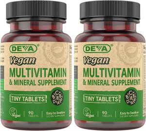 Two bottles of Deva Vegan Multivitamin & Mineral Supplement are displayed. The labels emphasize they are tiny, easy-to-swallow tablets, with 90 tablets per bottle. Suitable for both women and men, these vegan multivitamins proudly highlight their plant-based ingredients.