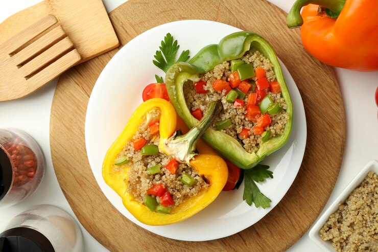 A plate featuring vegan stuffed bell peppers filled with rice and assorted vegetables, garnished for presentation.