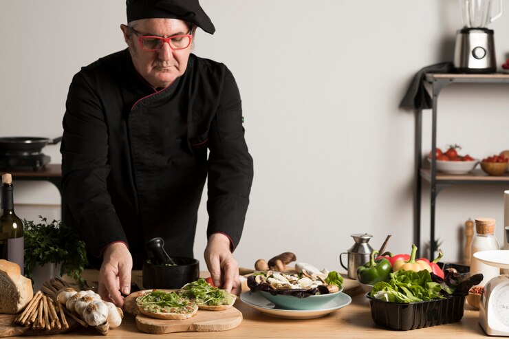 A vegan chef skillfully preparing fresh ingredients in a modern kitchen, showcasing culinary expertise and creativity.