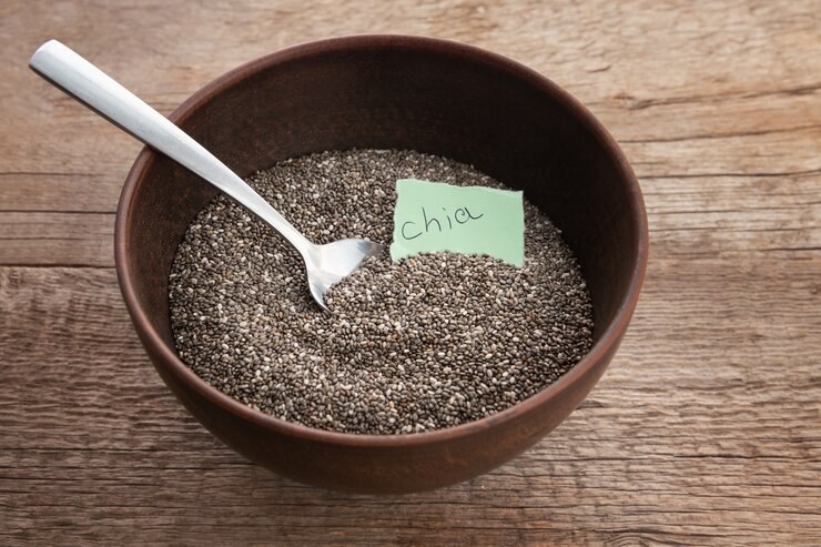 Chia seeds in a bowl with a spoon, highlighting their use as a vegan alternative to eggs in cooking and baking.