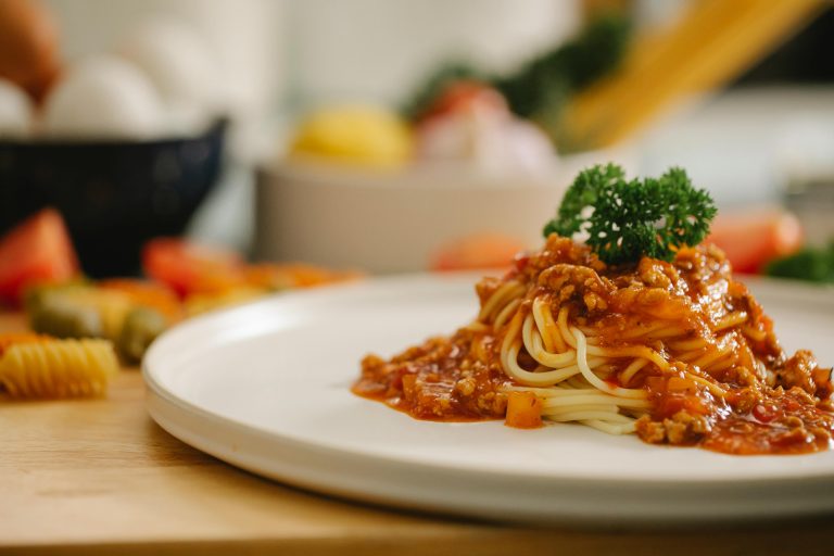 Quick and Easy Vegan Lentil Bolognese Recipe A plate of spaghetti topped with rich meat sauce, showcasing a delicious vegan lentil bolognese recipe.