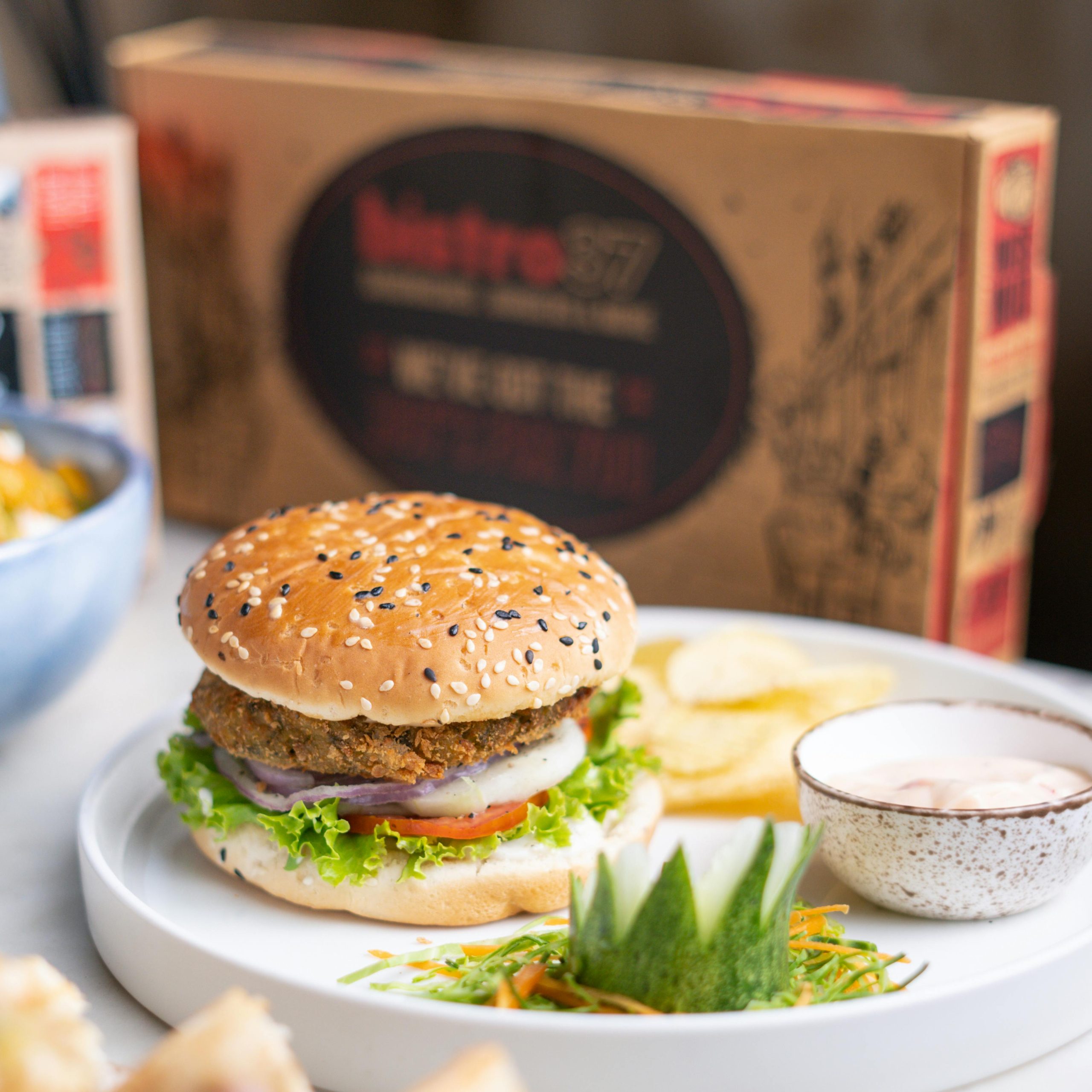 A vibrant plate featuring a plant-based burger alongside crispy chips, showcasing trendy dining options.