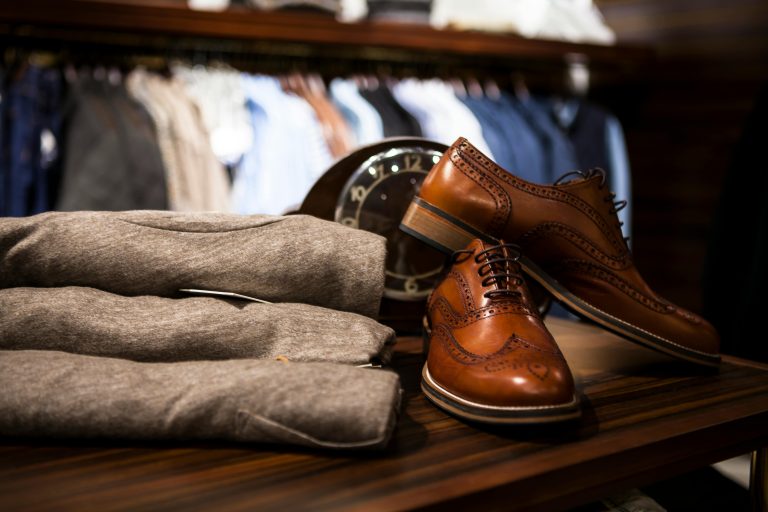 A stylish display of brown vegan leather shoes paired with trendy pants, showcasing the latest in sustainable fashion.