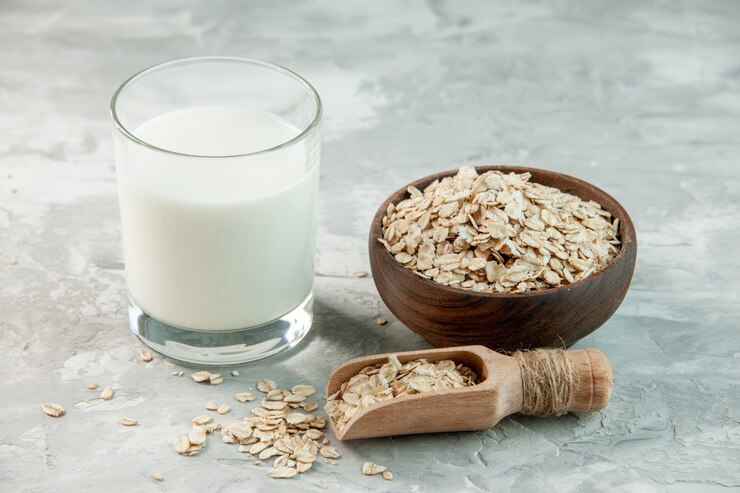 A bowl of oats with oat milk on a gray background, ideal for a nutritious breakfast cereal.