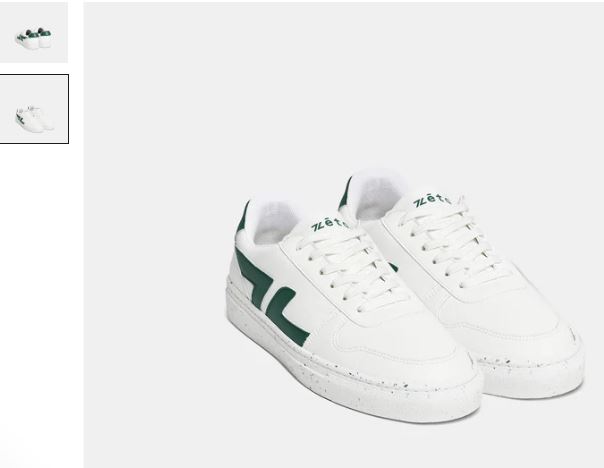 A pair of white vegan sneakers with green detailing, featuring Alpha Grape Leather by Zeta Shoes.