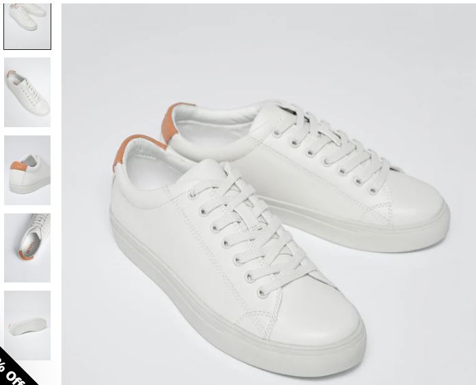 White leather sneakers featuring orange trim and lace detail, designed as R-Kind Unisex Lunar Rock by Ration.L.