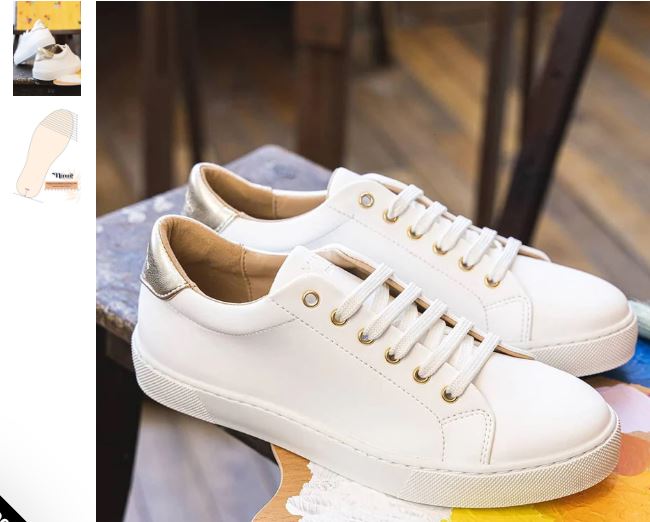 White leather sneakers with orange trim and lace detail, featuring a stylish design by Minuit sur Terre in vegan materials.