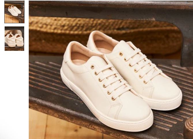 A pair of cream vegan sneakers with gold detailing, crafted from recycled grain leather by Minuit sur Terre.
