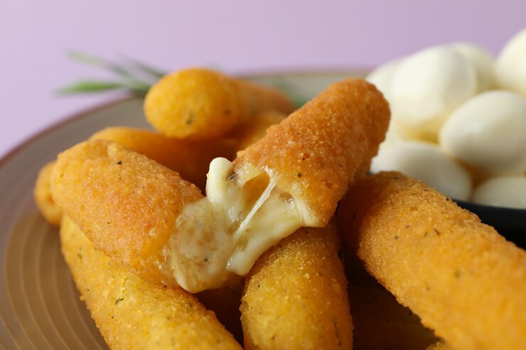 A plate of cheesy vegan mozzarella sticks, perfect for a heartfelt Valentine's Day celebration.
