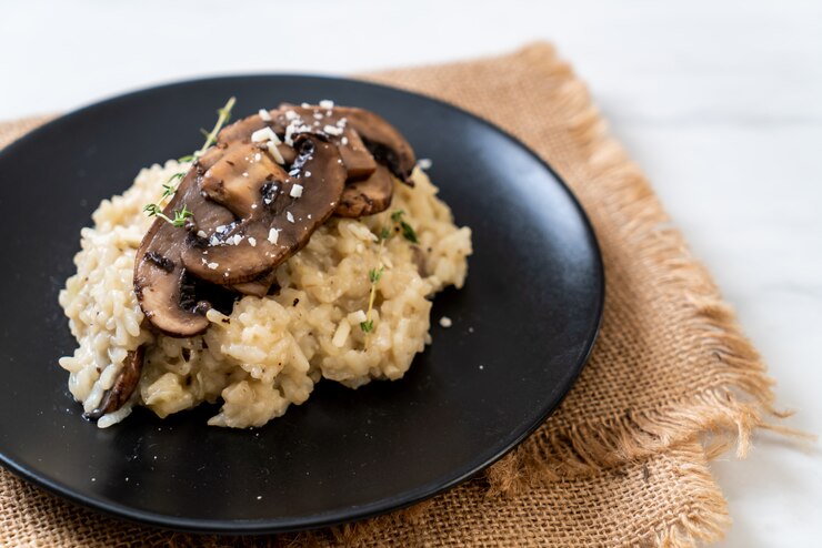 Creamy vegan mushroom risotto topped with parmesan, showcasing a delicious and quick meal option.