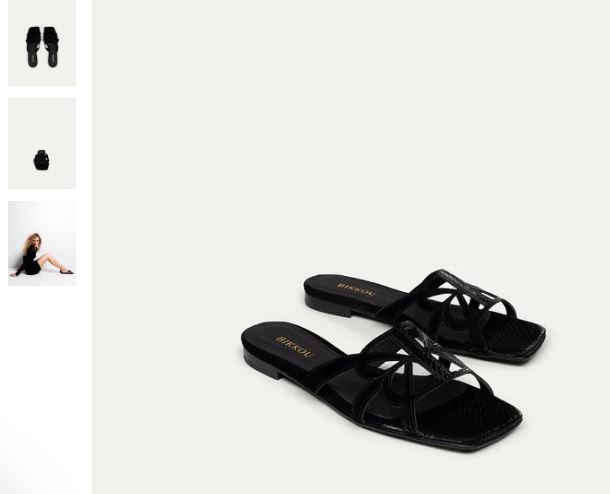 A pair of classic black vegan sandals featuring a bow on the toe, perfect for a sunset beach outing.