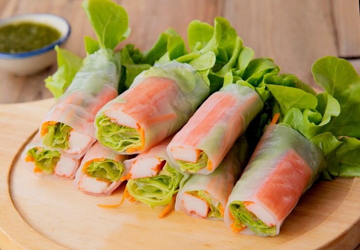 A plate of colorful vegan spring rolls filled with fresh vegetables and meat, perfect for a memorable Valentine's Day.