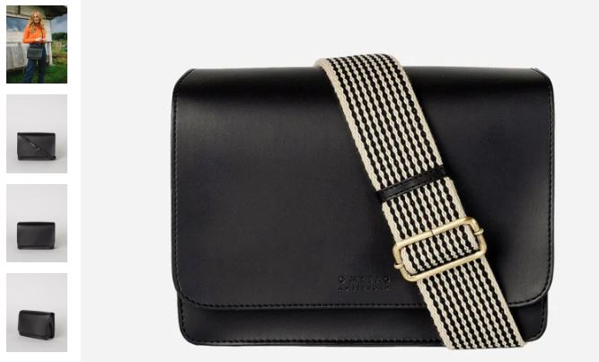 A black leather messenger bag featuring a stylish striped strap, showcasing the chic vegan design of the Uppealâ„¢ material.