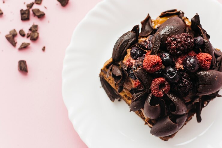 A rich Chocolate Cherry Vegan Cobbler adorned with berries, ideal for a romantic Valentine's Day dessert.