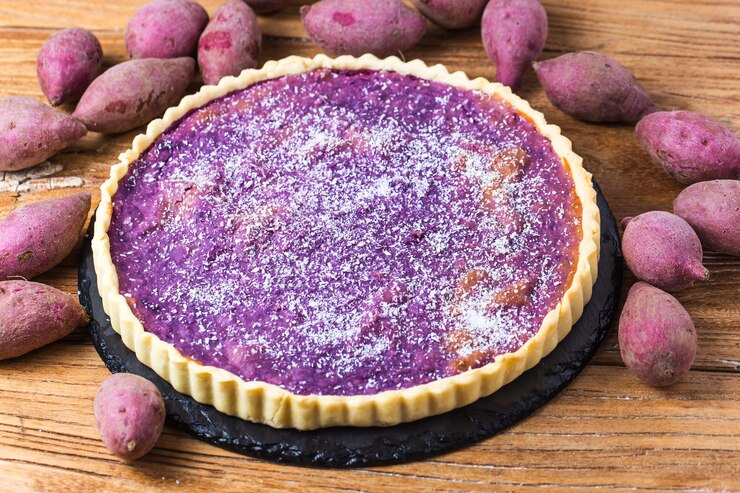 A beautifully crafted The Great Purple Sweet Potato Pie featuring purple potatoes, displayed on a rustic wooden table, perfect for Valentine's Day.