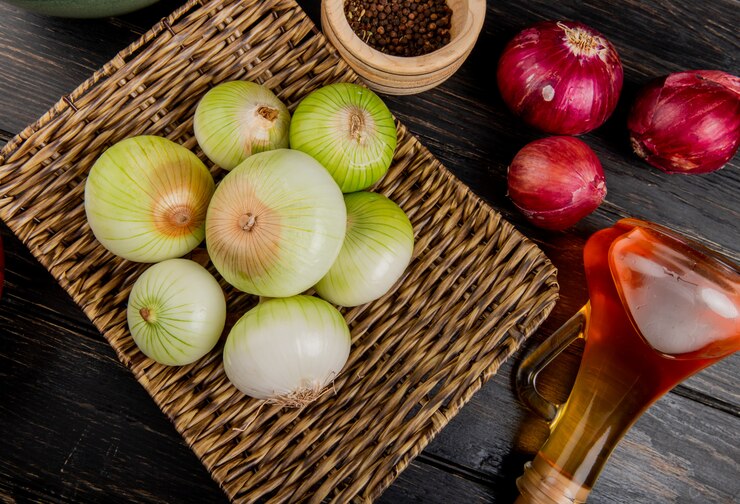 A table displays onions, garlic, and ingredients for Provençal stuffed onions with lentils, quinoa, and kale.