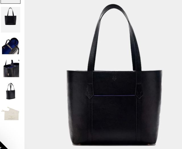A black and cobalt blue Maddox Vegan Leather Tote Bag filled with various items, showcasing its spacious design and style.