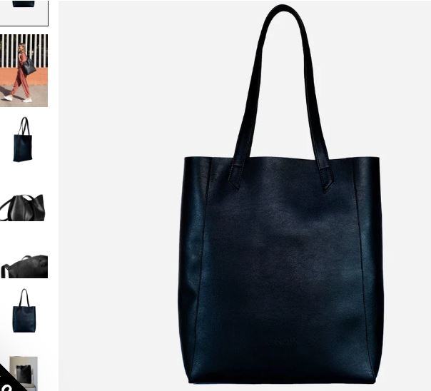 A black vegan leather tote bag paired with a matching black purse, showcasing a sleek and stylish everyday design.
