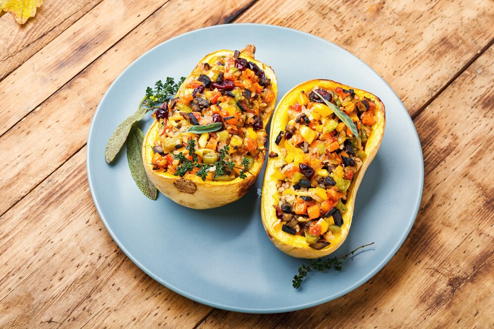 A blue plate holds two halves of stuffed butternut squash, highlighting a delicious summer recipe.