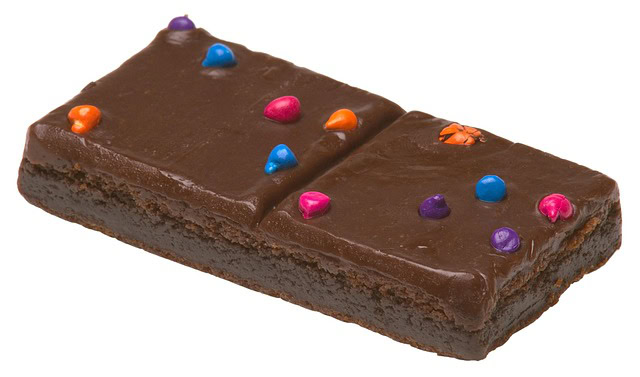 A piece of chocolate brownie adorned with sprinkles, representing a vegan version of a classic dessert.