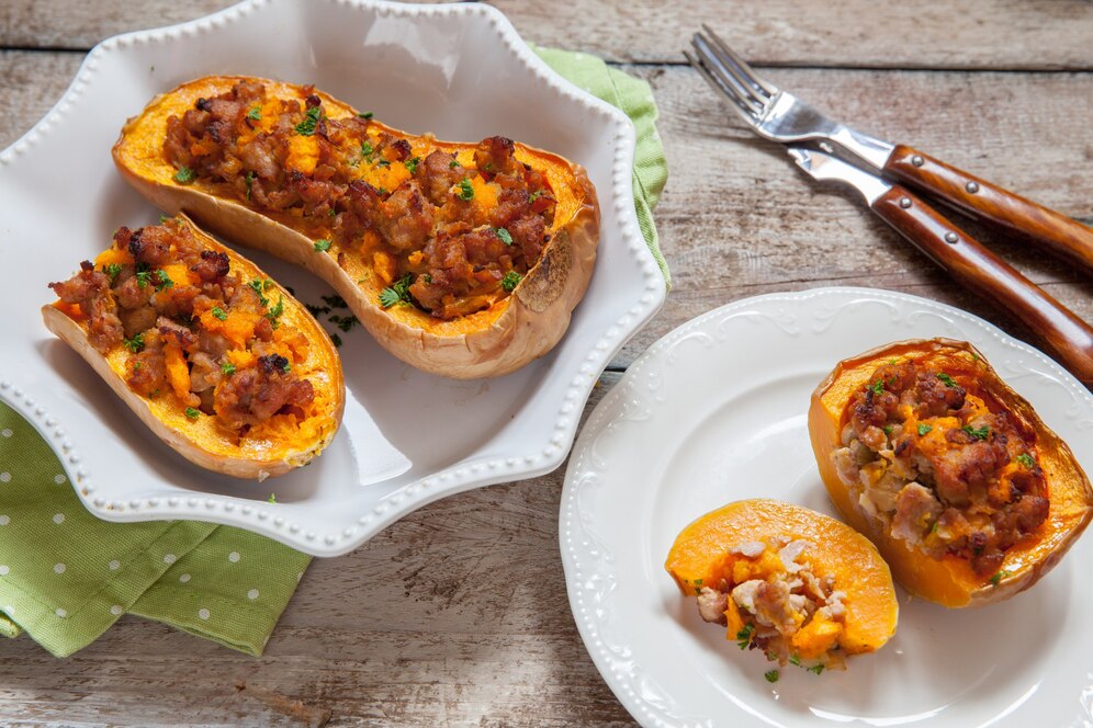 Two stuffed butternut squash halves on a plate, showcasing a delicious summer recipe.