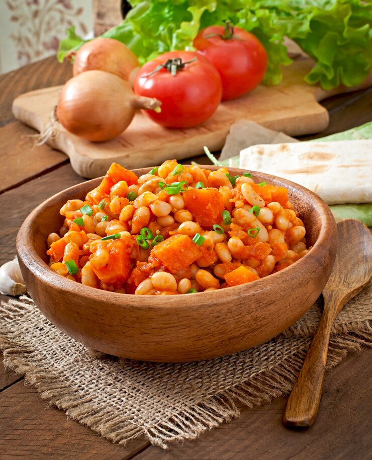 A bowl of Marry Me Butter Beans and vegetables on a table, showcasing the popular TikTok recipe.