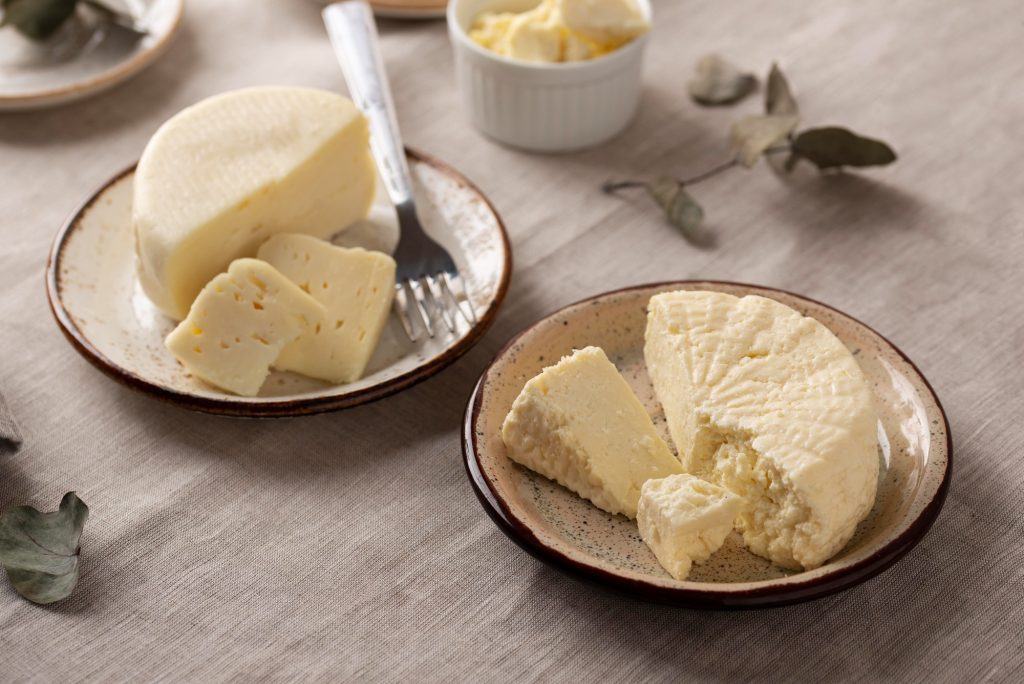 Butterkäse-style cheese wedges on rustic plates, used as inspiration for TikTok’s viral Butterkäse potato made vegan